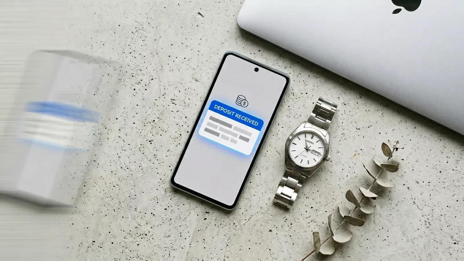 Smartphone showing an incoming bank deposit notification next to a wristwatch indicating same-day ACH funding for tribal installment loans