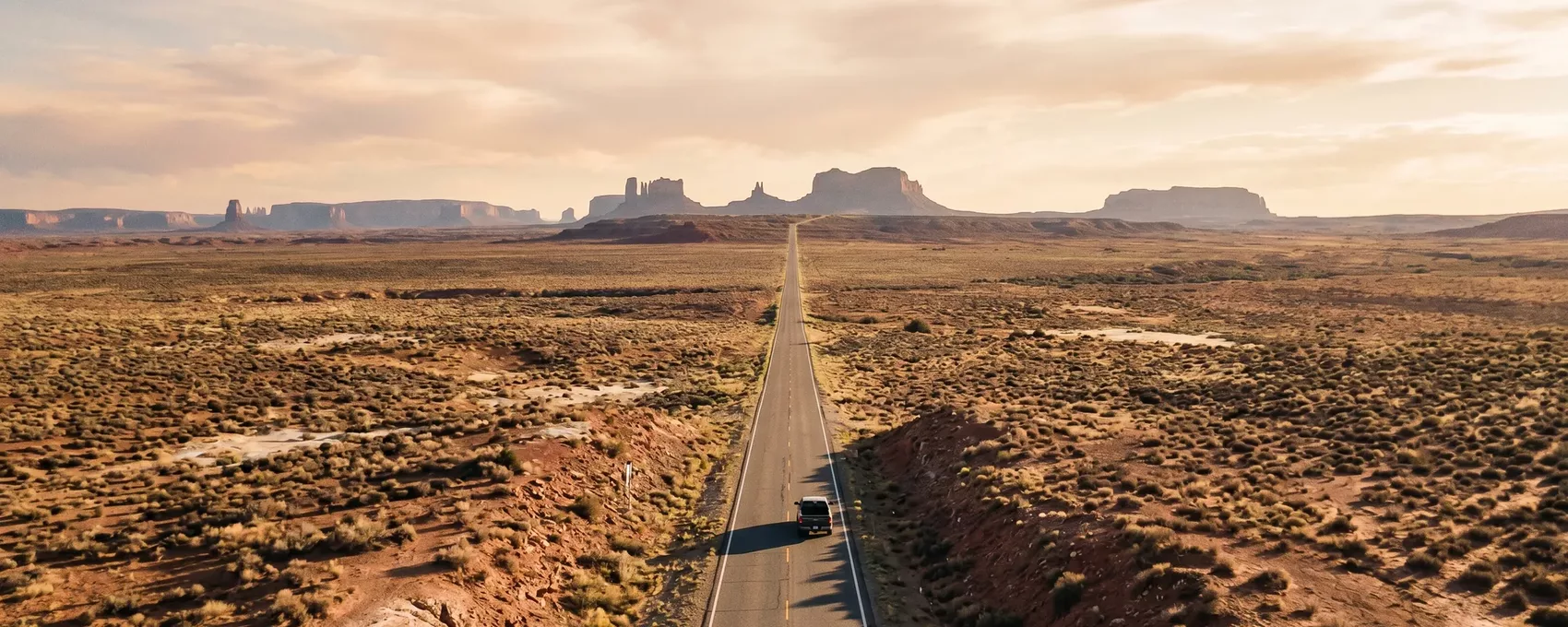Wide aerial panorama of the American landscape — plains, rivers, and mesas stretching across state lines
